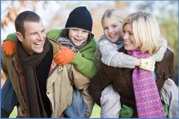 A picture a mom and a dad with children on piggy bag playing in cold weather