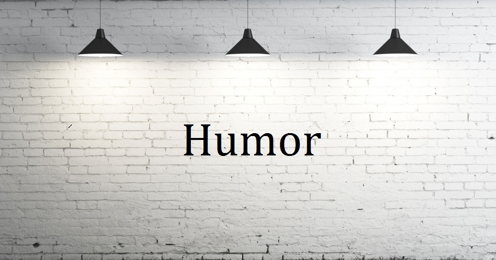 picture of a white wall with 3 lights and the word humor written on the wall